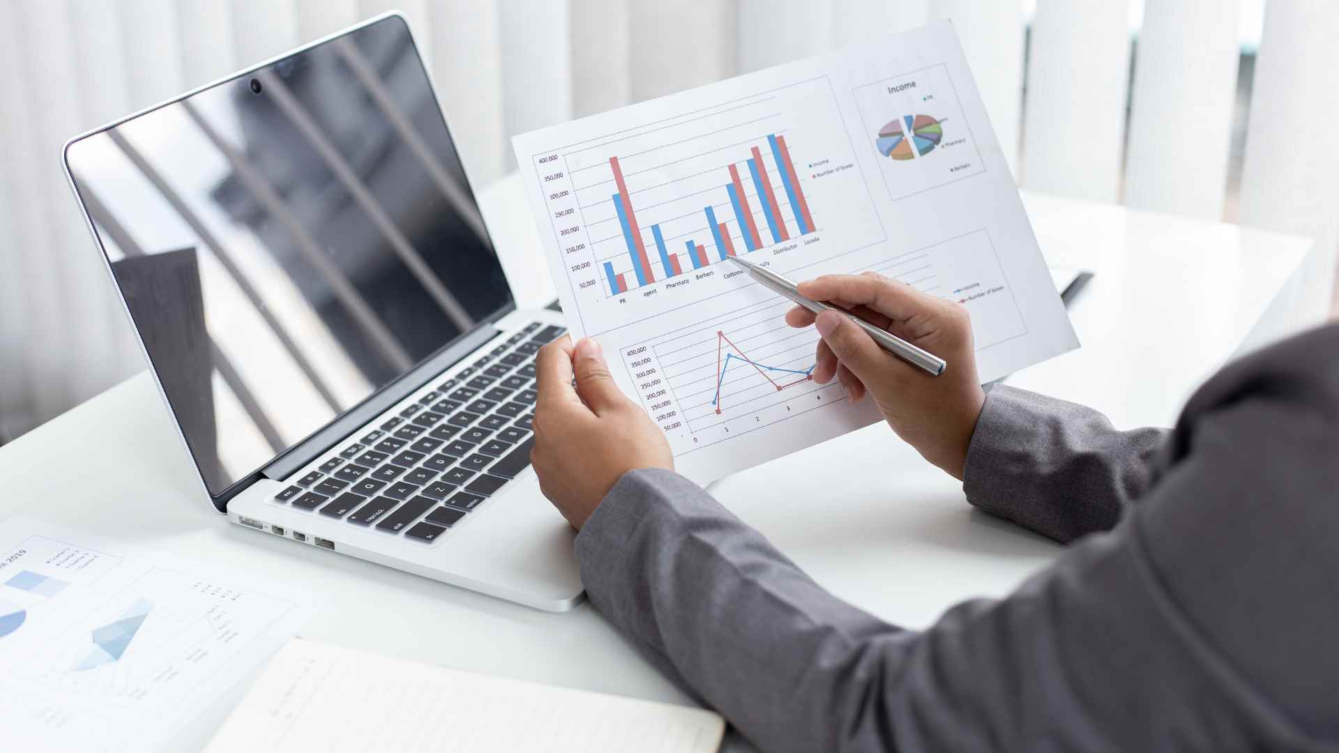 person sitting at desk reviewing financial report