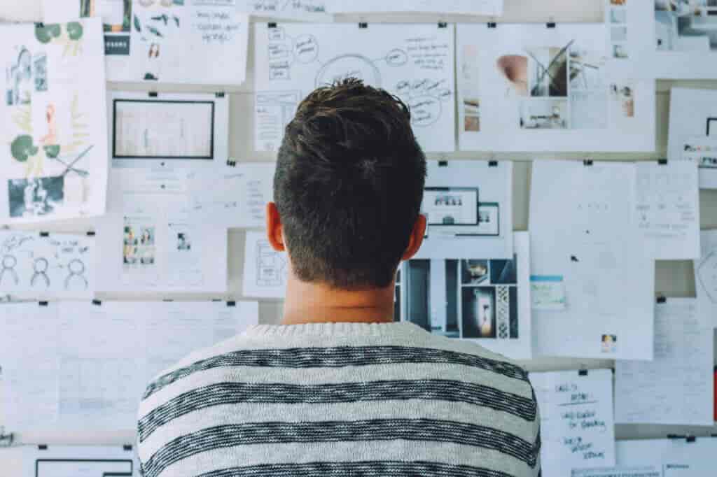 Man looking at wall of images